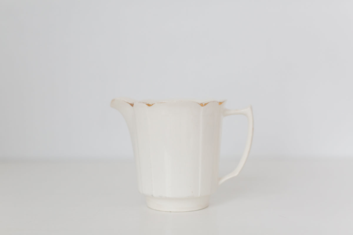 Vintage cream K T & K pitcher with gold accents