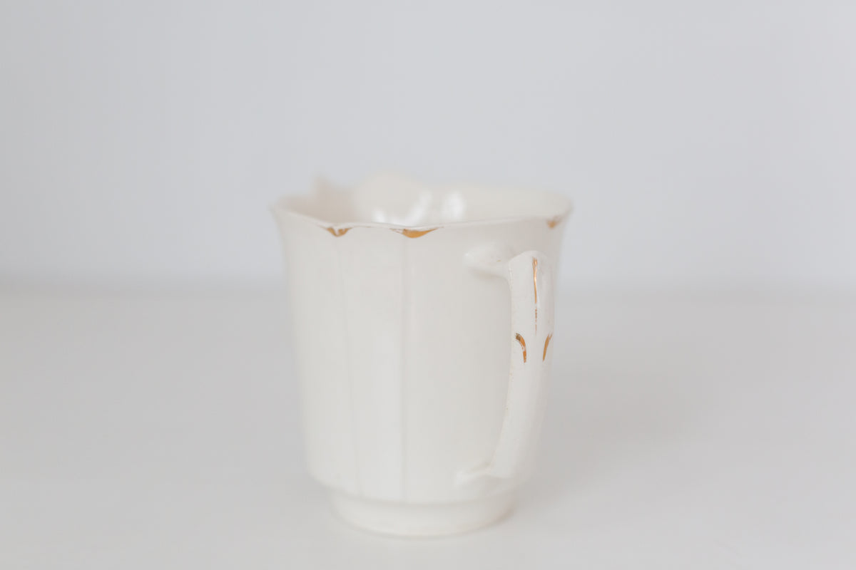 Vintage cream K T & K pitcher with gold accents