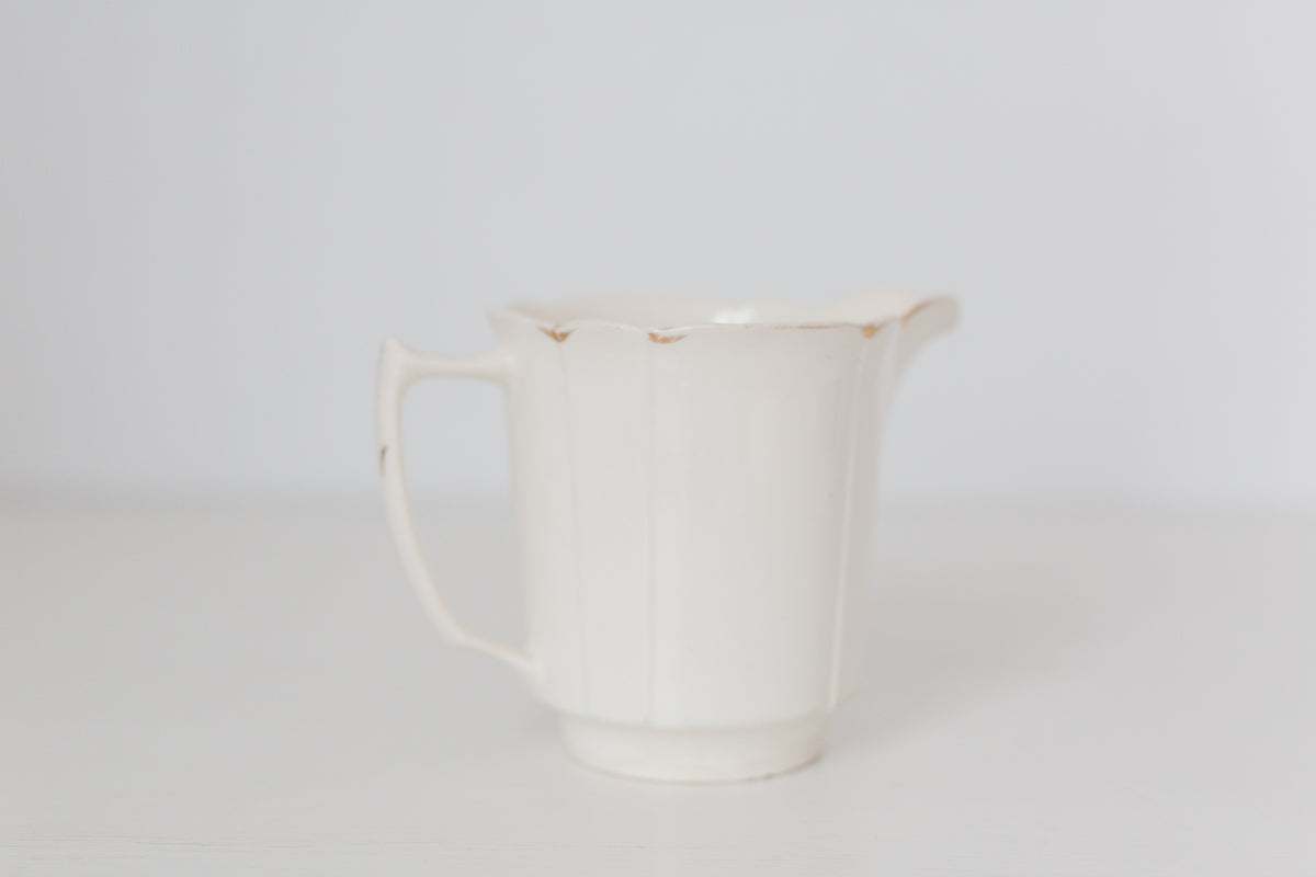 Vintage cream K T & K pitcher with gold accents