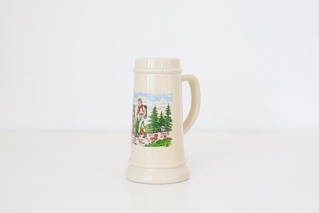 Vintage German beer stein with hiking image