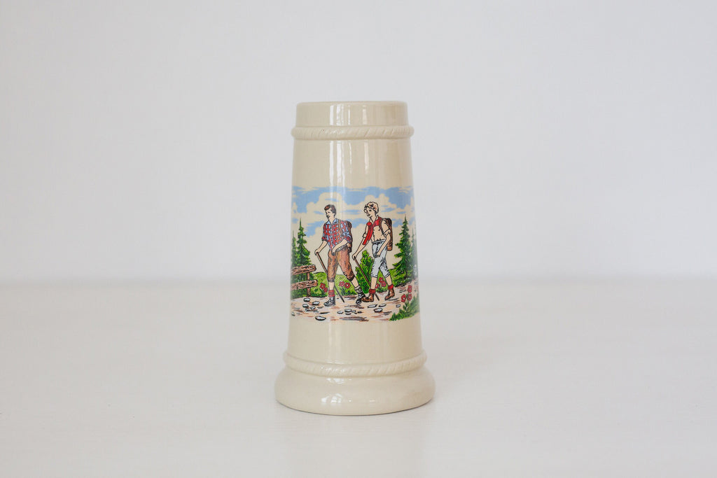 Vintage German beer stein with hiking image