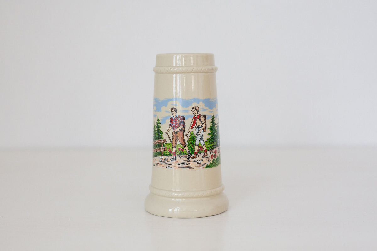 Vintage German beer stein with hiking image