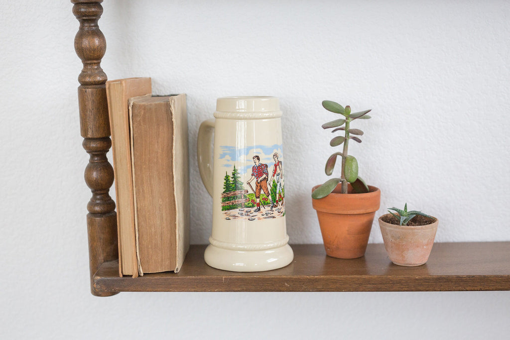 Vintage German beer stein with hiking image