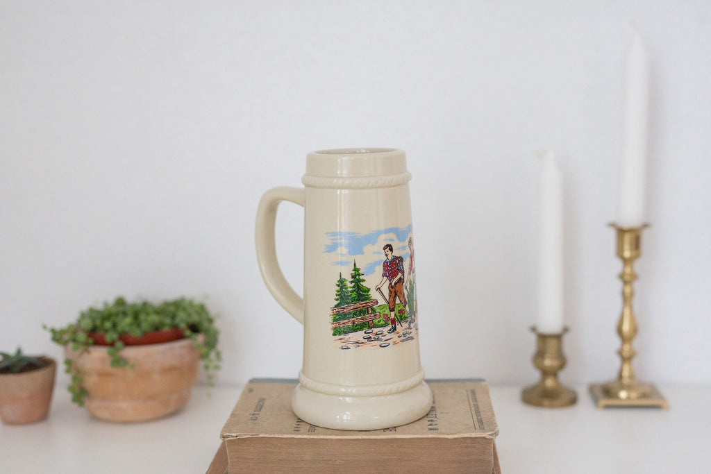 Vintage German beer stein with hiking image