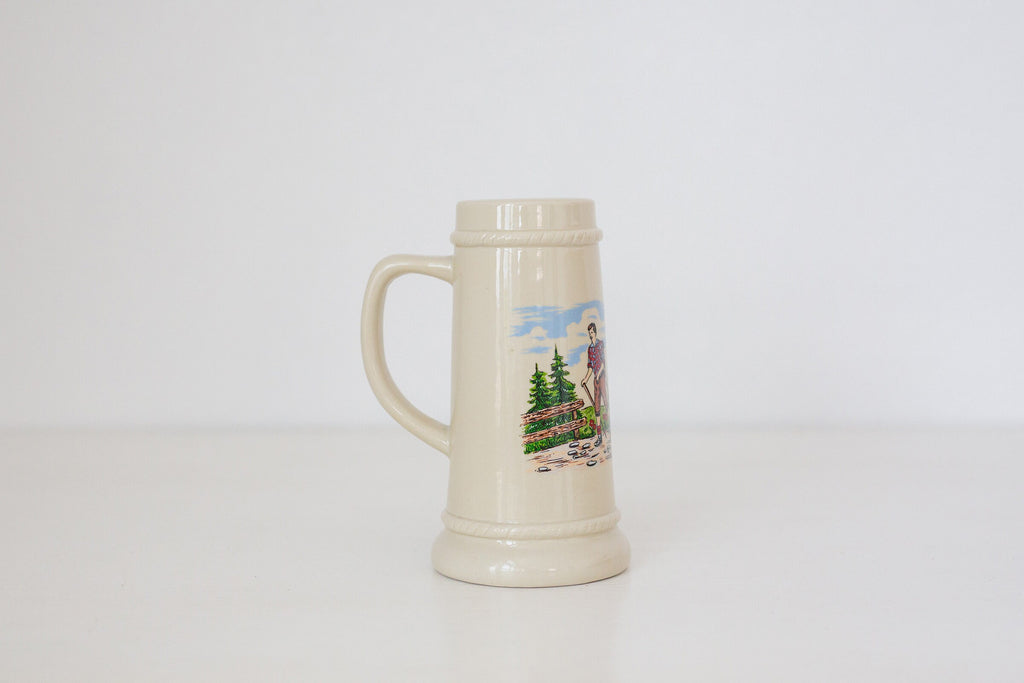Vintage German beer stein with hiking image