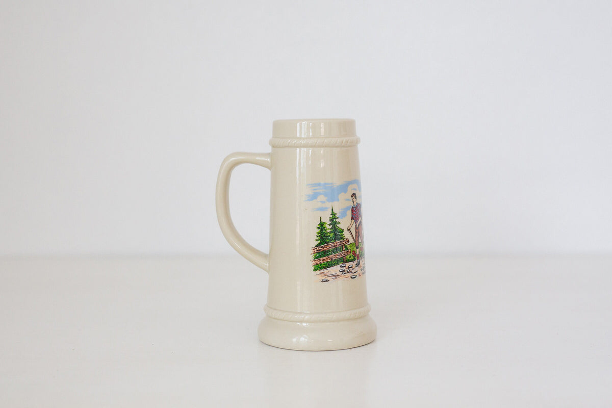 Vintage German beer stein with hiking image